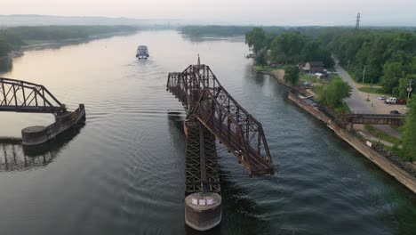 aerial view of a historic lifting bridge on a river with boats