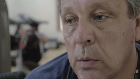 man catching breath after training in gym