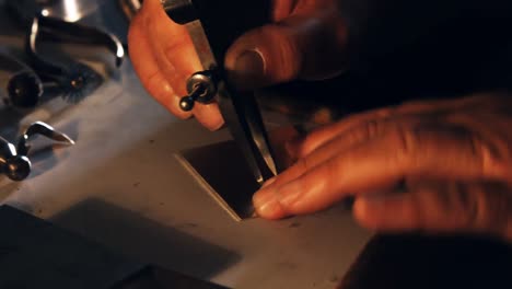 goldsmith working using divider compass