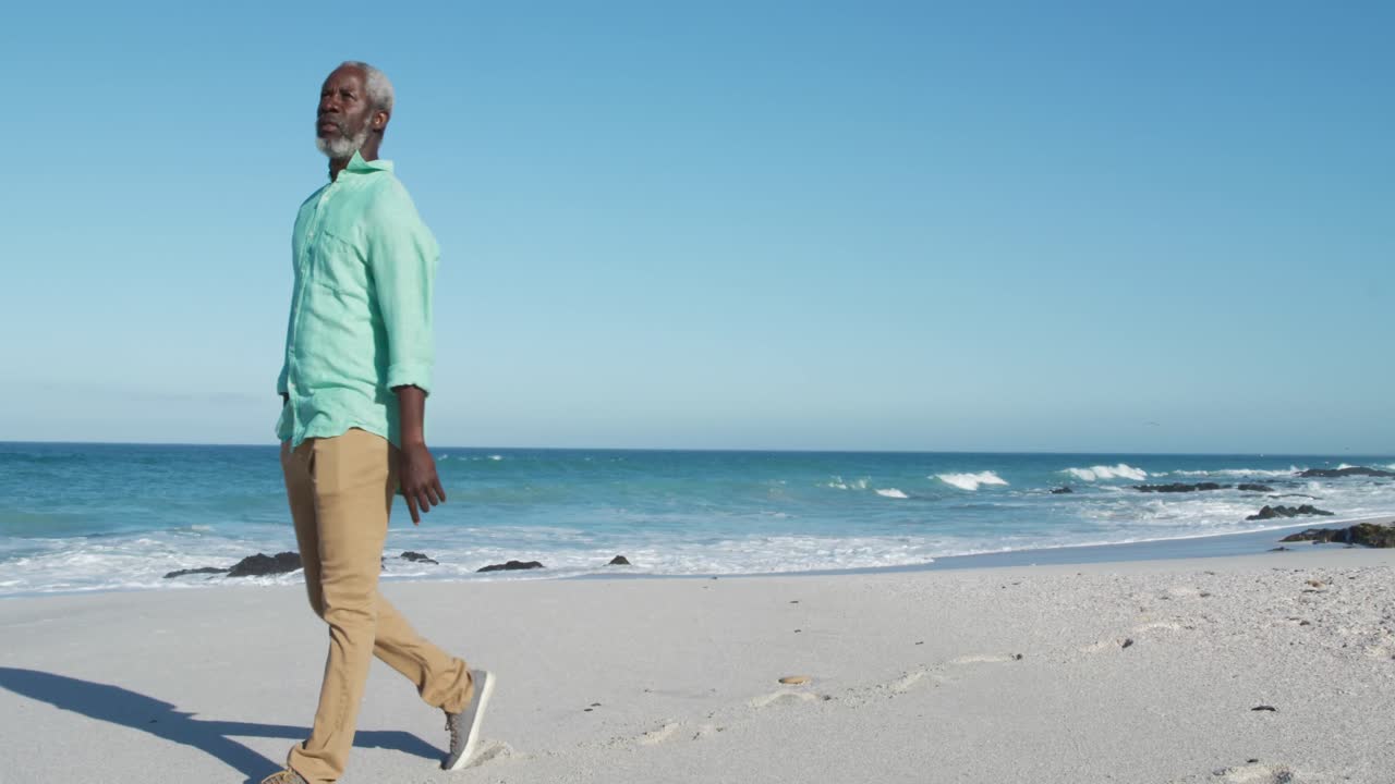 Senior man walking besides the beach
