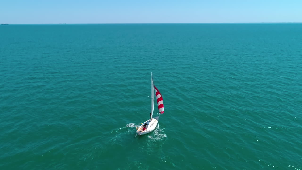 Aerial view of white boat in the sea. Modern yacht holding in the ocean