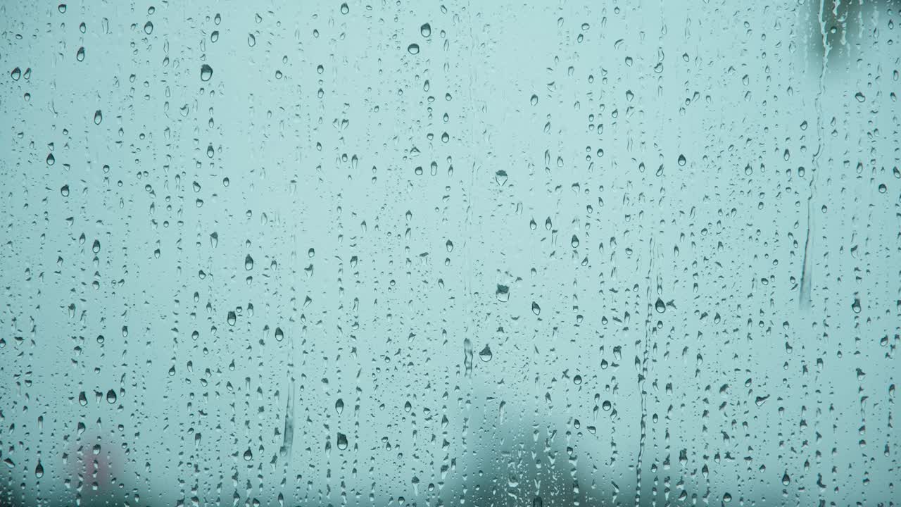 gotas de agua de lluvia cayendo sobre el vidrio de la ventana, gotas de lluvia sobre el vidrios de las ventanas, una toma de cerca de las gotas de aguas cayendo.