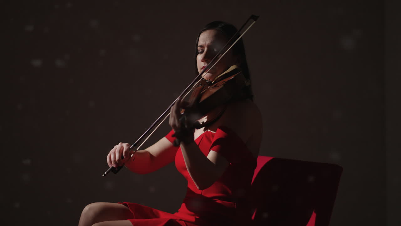 Woman Playing Violin in Red Dress