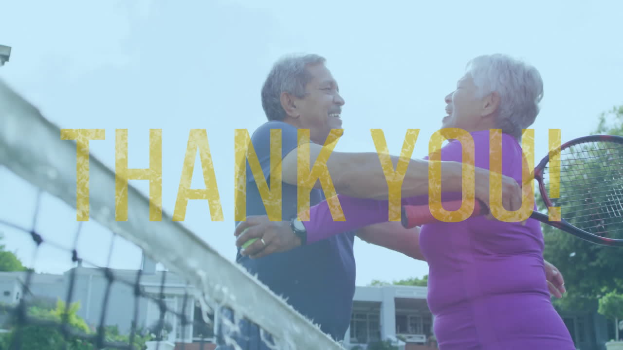 Senior woman and senior man hugging on tennis court, showcasing health with floating thank you text