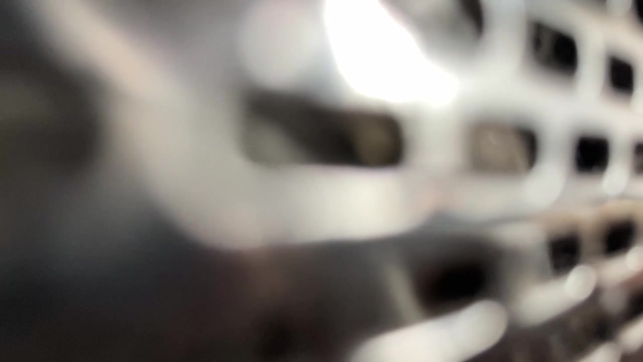 4K push in shot of blurred active speaker texture Abstract close up of audio equipment and grill cloth background loop perfect for music technology and hifi sound system broll footage