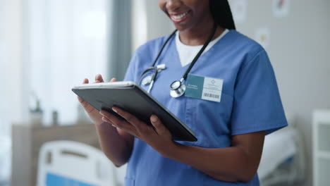 nurse using tablet in hospital room