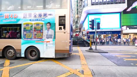 buses and cars navigate busy city intersection