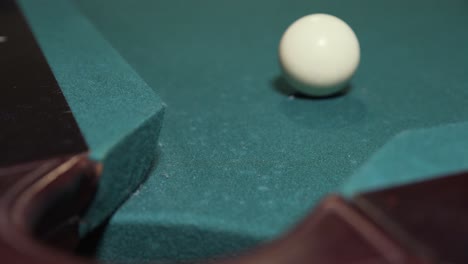 Player-sinking-black-8-ball-into-corner-pocket-to-win-game-of-billiards