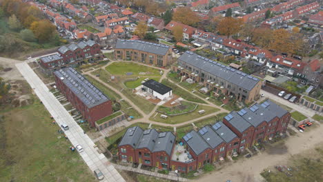 Aerial-orbit-of-small,-new-neighborhood-with-solar-panels-on-rooftop