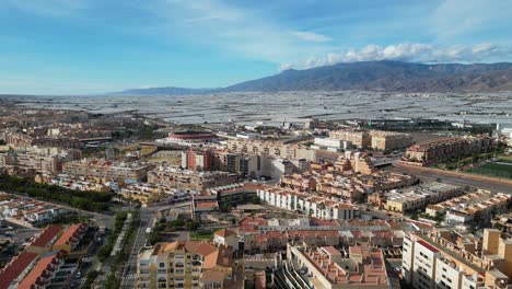 Roquetas-de-Mar-Cityscape-and-Greenhouses-in-Almeria,-Andalusia,-Spain---Aerial