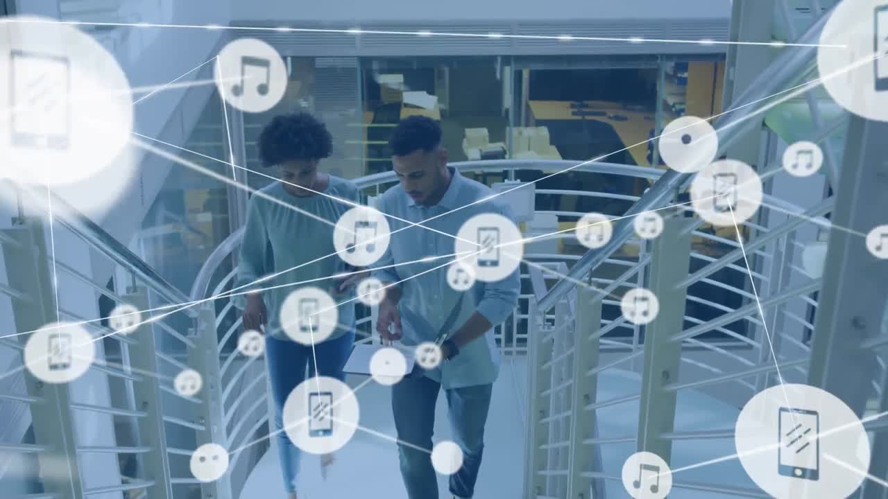 Animation of network of digital icons over diverse man and woman discussing on stairs at office
