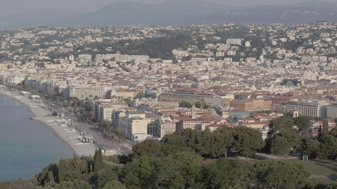 Aerial view in French Riviera with people on the beach in Nice during summer day close to forest
Long travelling drone shot in the french riviera during summer
Lot of people on the beach and swimming