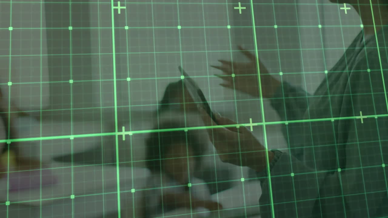 Green grid overlay animation over person using tablet in blurred background