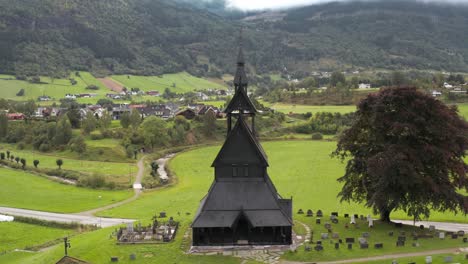 black hopperstad stave church in village valley, countryside of norway