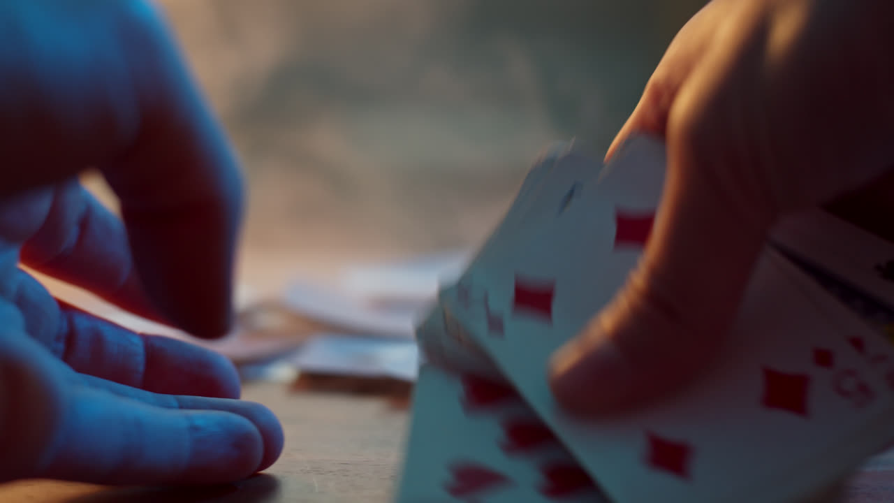 Hands shuffling a deck of cards