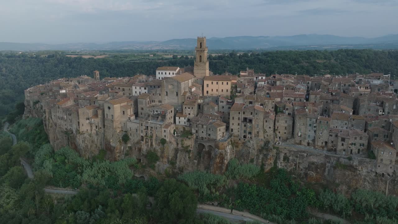 Aerial Drone view of the hilltop Medieval town of Pitigliano, Tuscany in morning light, with the Valdorcia and old buildings, in 4K