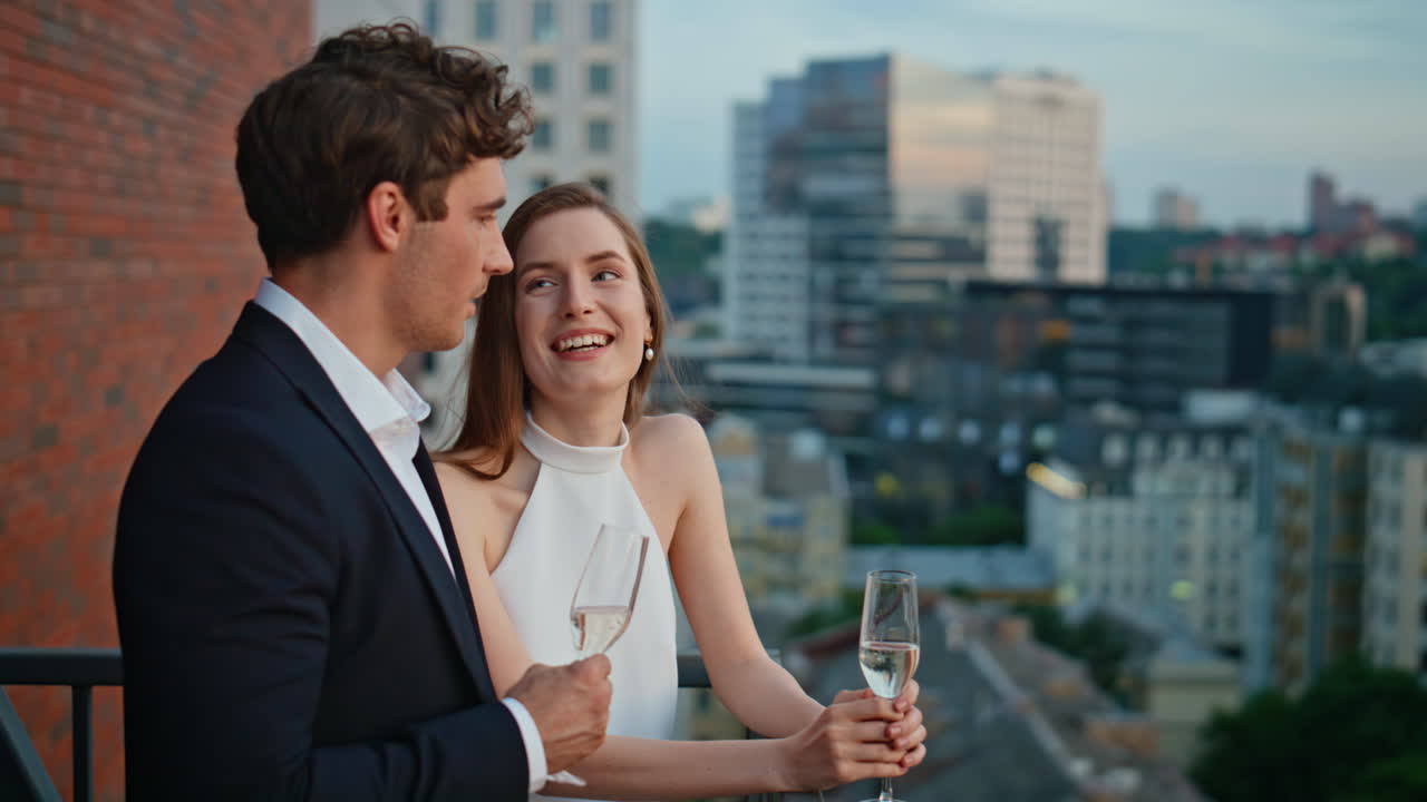 pair flirting date holding champagne closeup. Smiling spouses romantic