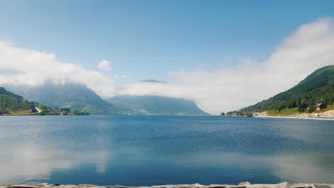The-Shore-Of-The-Fjord-The-Top-Of-The-Mountains-Are-Drowning-In-The-Clouds-View-From-The-Window-Of-T