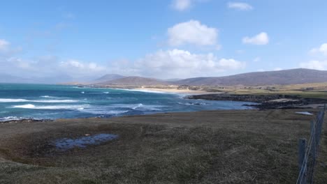 Overlooking-rural-farming-countryside-landscape-towards-ocean-and-waves-rolling-in-on-the-isle-of-Lewis-and-Harris,-Outer-Hebrides,-Western-Scotland-UK