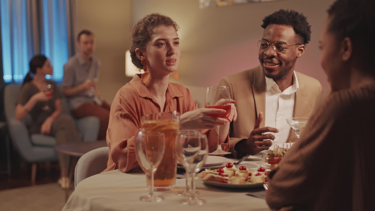 Friends Communicating at Dinner Party at House