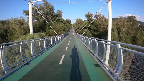 first person gopro point of view cycling over bridge in nature, slovakia