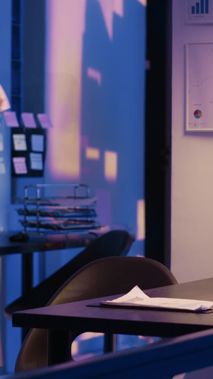 Vertical video: Exhausted manager working overtime on research plan