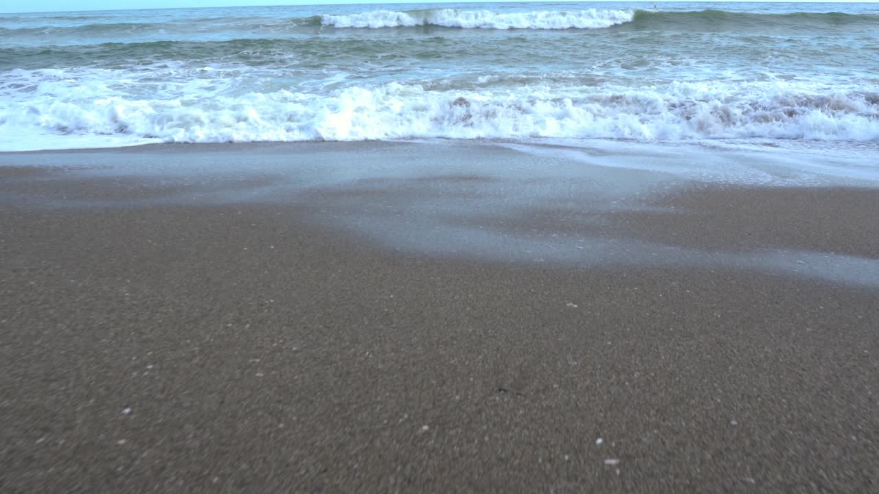 Walking towards the sea. Dolly in, walkers POV
