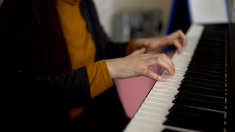 hands of women play on the electronic synthesizer