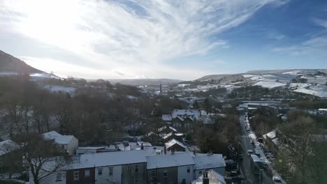 cold snowy winter cinematic aerial view cityscape townscape with snow covered roof tops panorama 4k marsden village west yorkshire, endland