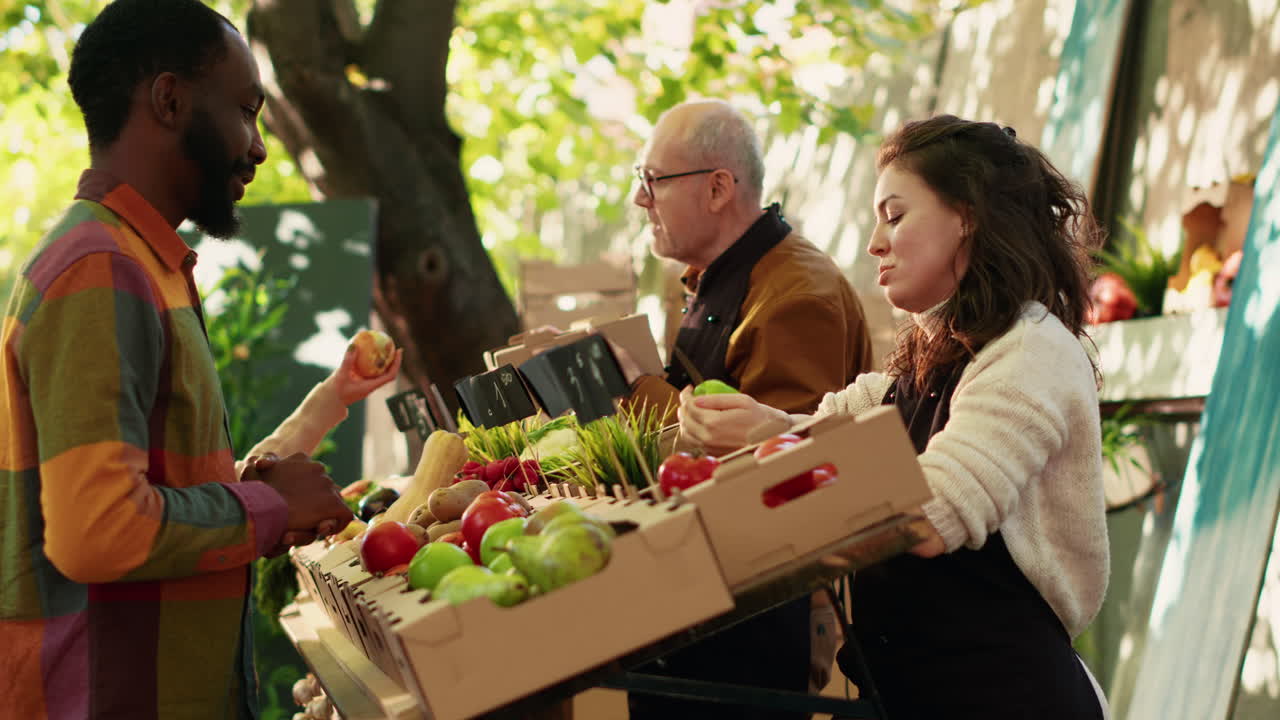 People shopping for fresh produce at an outdoor farmers market