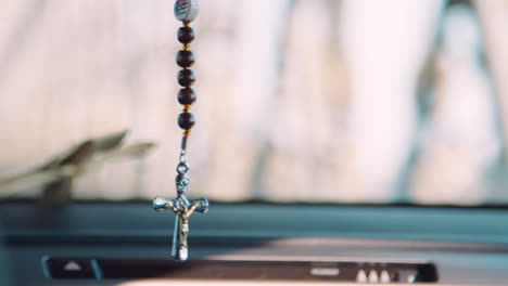 close up of crucifix hanging inside car in new york