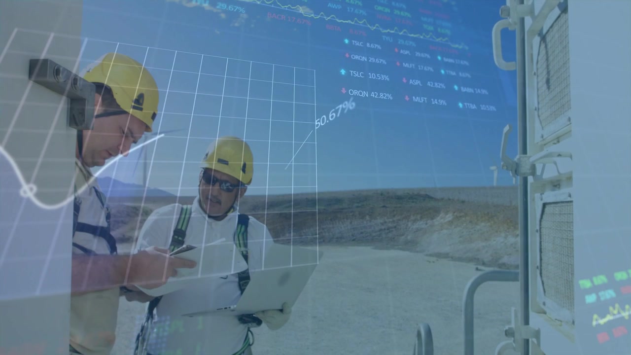 Two techs pointing and consulting laptop and tablet, growing animated charts for wind energy
