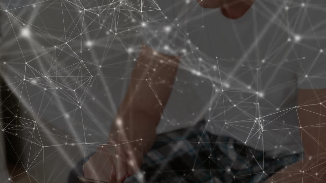 mature man leaning forward interacting with laptop, with animated network overlay for technology