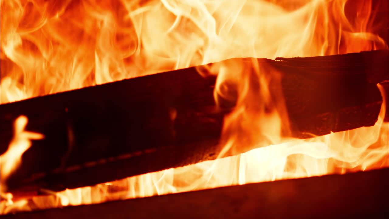 Close up of wood burning with a strong flame in a fireplace