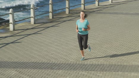 senior woman running on a promenade