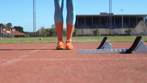 Low-section-of-female-athlete-exercising-on-running-track-4k