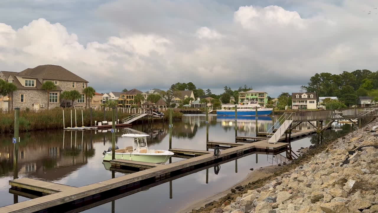 Boats and Luxury Homes Reflected in Calm Residential Canal