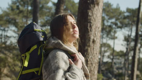 young woman backpacker hiking in the forest on a sunny day 2