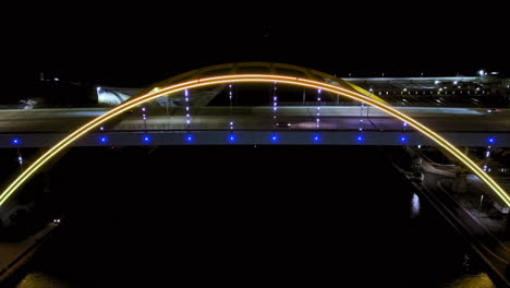 aerial view tilting in front of the hoan bridge, nighttime in milwaukee, usa