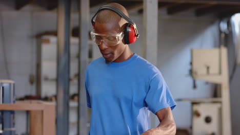 african american coworkers cutting plank in shop with yellow jigsaw and safety goggles, copy space