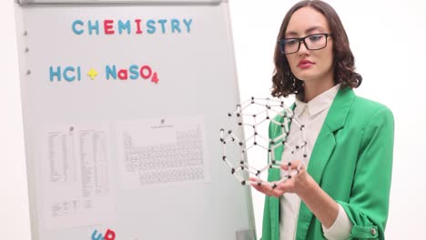 woman teacher explaining chemistry with molecular model