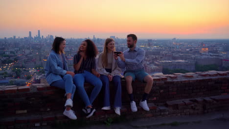 friends enjoying city view at sunset