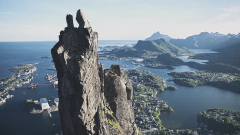 person trad climbing to top of svolværgeita in norway, lofoten