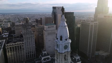 statue of  william penn on philadelphia city hall tower. beautiful cityscape. business district and downtown  sunlight. delaware river. pennsylvania