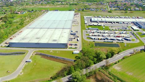 aerial view of warehouse storages or industrial factory or logistics center from above. top view of industrial buildings and trucks