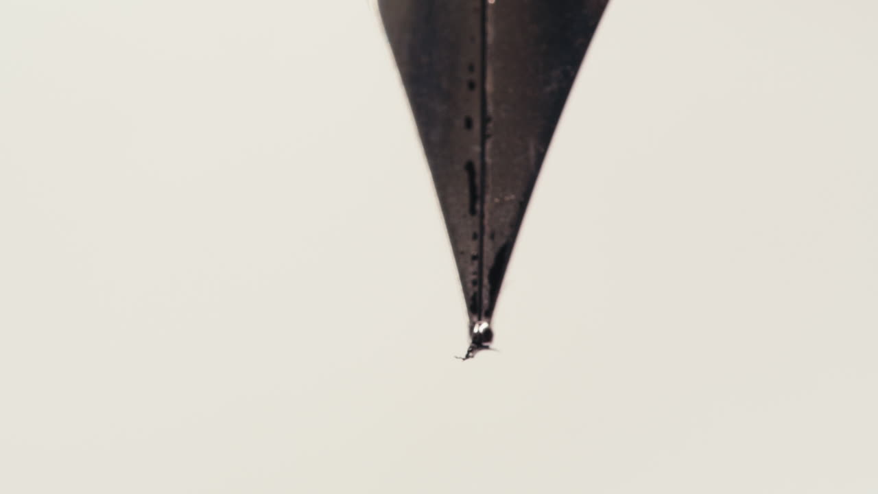 Close Up of Fountain Pen Nib Writing a Line on White Paper