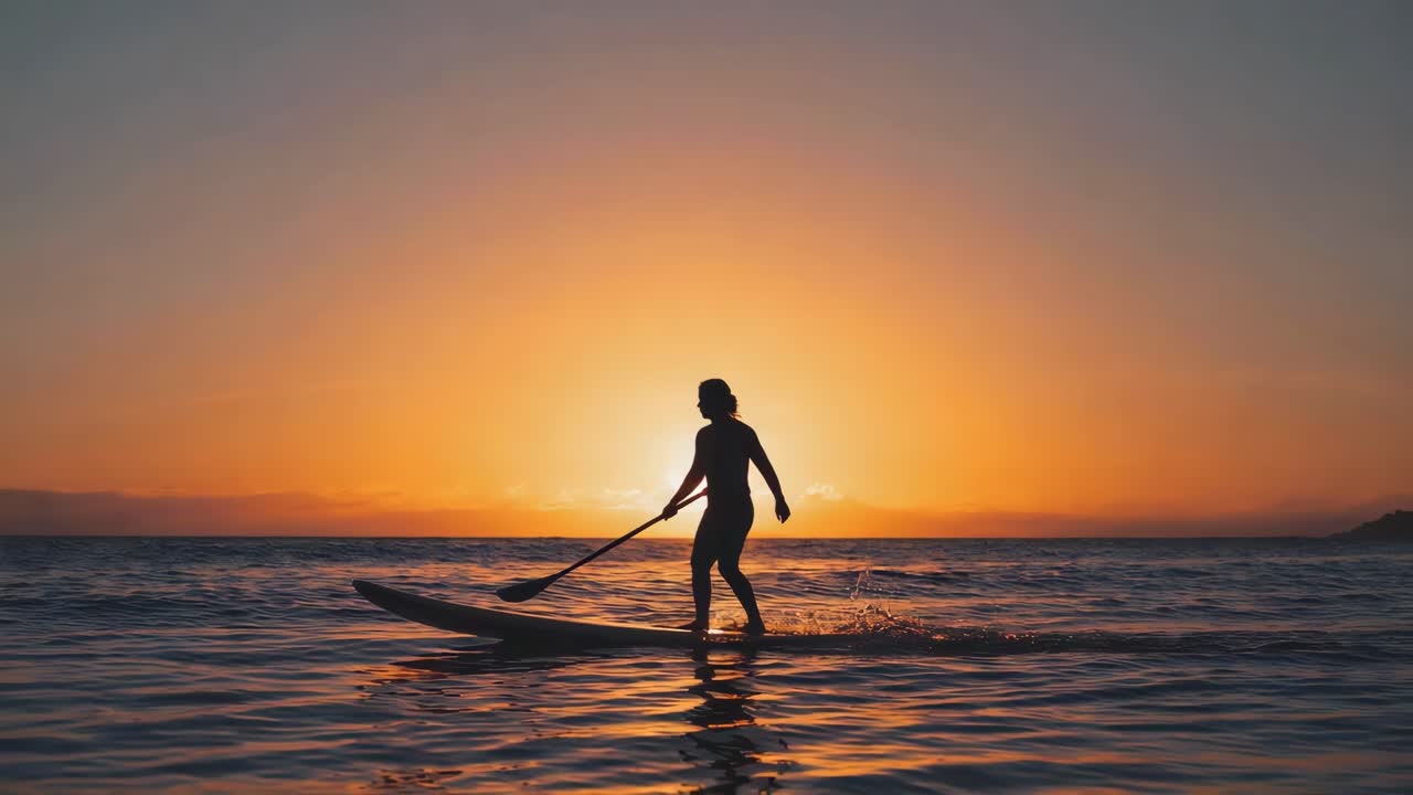 Silhouette Paddleboarding at Sunset