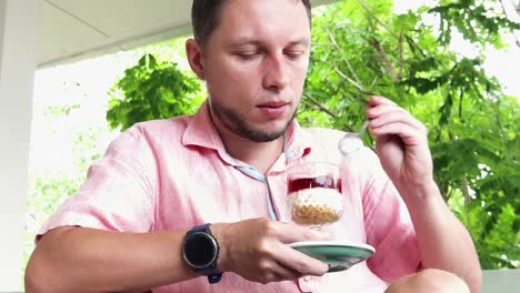 man eating dessert outdoors