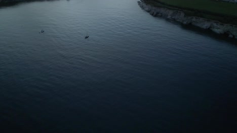 Aerial-fly-in-pan-up-of-Swanpool-beach-and-coast-Falmouth-Cornwall-England-UK