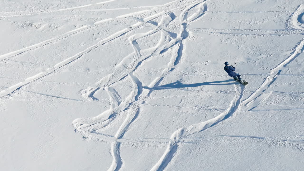 Aerial drone view of a sportsman snowkiting on the Giau Pass in the Dolomites, Italy